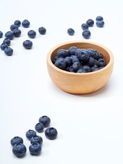 blueberry in wooden bowl on white background
