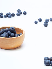 blueberry in wooden bowl on white background