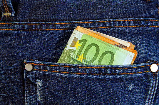 euro money cash, euro banknotes in the pockets of jeans trousers.  banner for web, giftcard, postcard. Concept of wealth, saving or spending money. Irresponsible action. copy space, top view. 