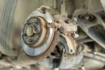 car suspension repair on a lift jack in auto service close-up