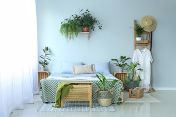 Interior of modern bedroom with houseplants