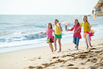 Children at sea. Little girls run on the sea on the waves. 