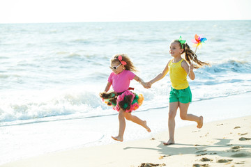 Naklejka premium Children at sea. Little girls run on the sea on the waves. 
