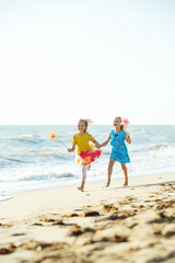 Children at sea. Little girls run on the sea on the waves. 