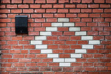 Fototapeta na wymiar Old red and white brick wall. Mailbox. Space for lettering or design