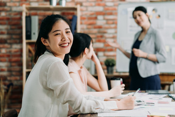 confident beautiful female worker looking at camera posing and smiling. pretty women partners...