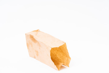 Crumpled brown paper bag on white background