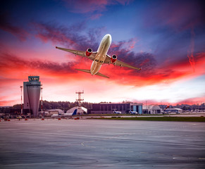 A plane with the beautiful sunset view and dark cloudy sky above the sea.