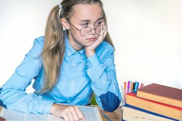 Fototapeta na wymiar Stressed school girl tired of hard learning with books in exams tests preparation, overwhelmed high school teen girl exhausted with difficult studies or too much homework, cram concept