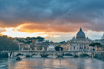 St. Peter's cathedral and Tiber river with high water at evening with dramatic sunset sky. Saint...