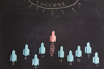 different, individuality vision or idea.Think outside the box, innovation way. Red paper rocket...