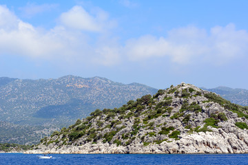 Fototapeta na wymiar Rocky islands forested in the Mediterranean Sea. Concept - Tourism