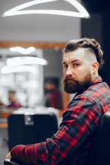 Handsome man in a white shirt. Businessman in a barber shop