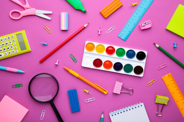 Back To School concept. School supplies on pink background, top view