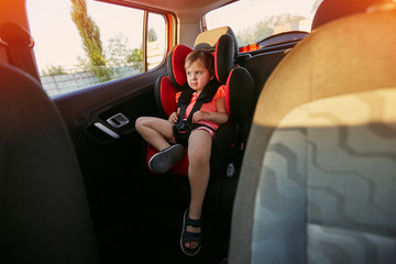 Fototapeta premium Adorable baby in safety car seat.
