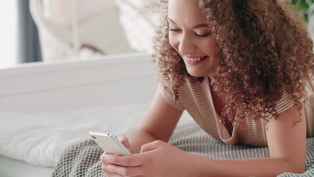 Happy teenage girl using a mobile phone