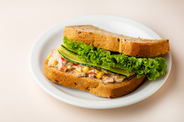 Sandwich with tuna and vegetables on plate