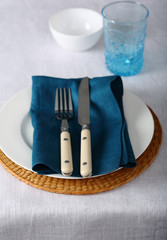 White linen cloth and blue napkin