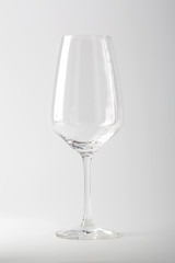 Empty white wine glass on white backdrop