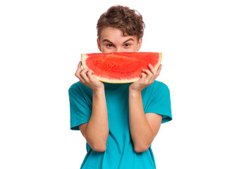 Portrait of teen boy eating ripe juicy watermelon and smiling. Cute caucasian young teenager, isolated on white background. Funny happy child covered his face with slice red watermelon.