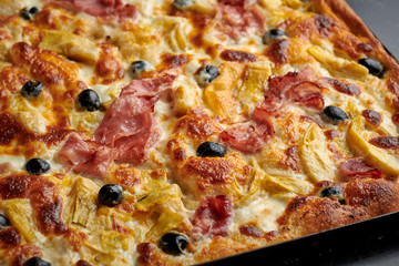 Italian focaccia bread with olives, ham and artichokes