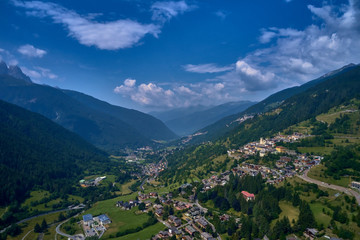 Naklejka na ściany i meble Panoramic view of the Ponte di Legno region of Trento the north of Italy. The popular ski resort town of Ponte di Legno. Summer time of the year. Aerial view. Photo taken on a drone.