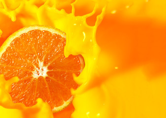 Orange fruit cut in half with orange juice splash