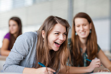 College students in classroom during class, paying attention to the teacher (color toned image)