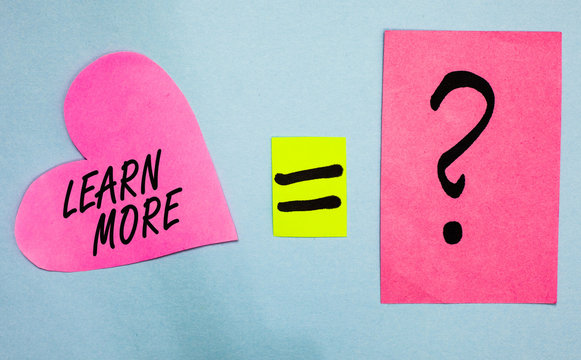 Text sign showing Learn More. Conceptual photo Deepen knowledge of the thing you want to do or new skill Pink paper notes heart equal sign question mark important answer romantic