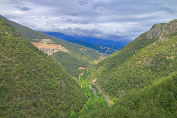 Fototapeta na wymiar Storm over a narrow canyon in the mountains.