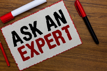 Text sign showing Ask An Expert. Conceptual photo Superior Reliable Ace Virtuoso Curiosity Authority Geek White paper red borders markers wooden background communicating ideas