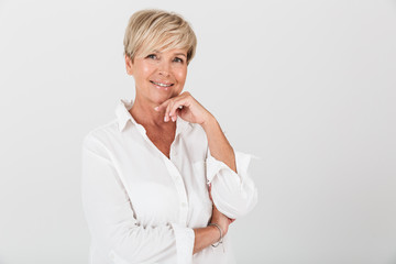 Portrait closeup of happy adult woman with short blond hair smiling at camera