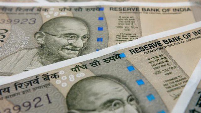Closeup shot of revolving Indian 500 rupee notes. 