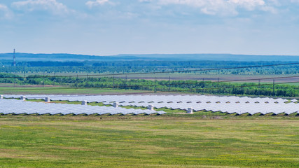 Solar power plant in the steppe area. Summer flat landscape