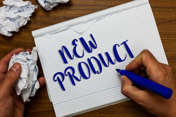 Conceptual hand writing showing New Product. Business photo showcasing goods and services that differ in their characteristics Man holding marker notebook crumpled papers ripped pages