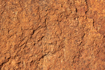 Fototapeta premium A fragment of the surface of a stone made of granite with a large grainy structure. Background, texture