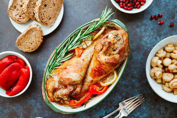 Festive dish for Thanksgiving, roasted turkey legs with vegetables on a table with snacks. Top view, flat lay.