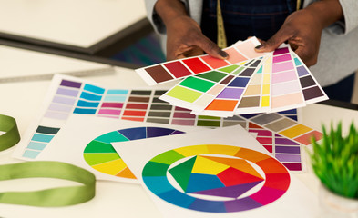 Afro Female Hands Choosing Color Samples In Design Studio, Closeup