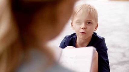 Little boy talking to teacher in the preschool