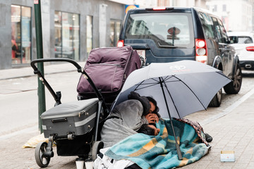 Bruxelles, Belgium - May 2019: homeless immigrants or tourists sleeping on the streets of Brussels. Problems with insurance.