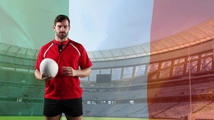 Professional rugby player standing in front of a flag and stadium - Powered by Adobe