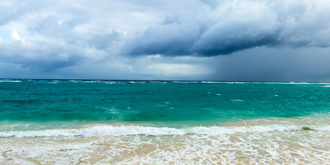 Panoramic photo of the beginning of a storm on a wild ocean beac