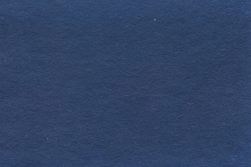 Cardboard texture close-up. Dark old paper background. Grunge concrete wall. Vintage blank wallpaper.