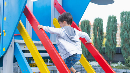 Happy smiling child on playground. Happy kids playing outdoors