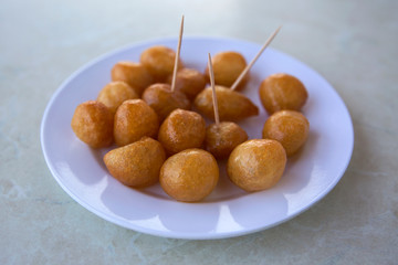 Traditional Turkish Lokma Sweet, fried sweet dough covered in a syrup and served