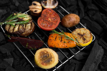 Close up of cooking of grilled vegetables on grid on coals