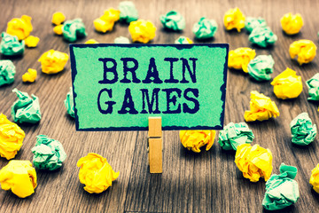 Text sign showing Brain Games. Conceptual photo psychological tactic to manipulate or intimidate with opponent Clothespin holding green note paper crumpled papers several tries mistakes