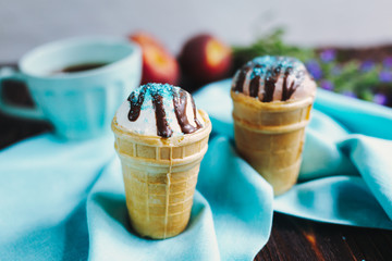 Vanilla and chocolate ice cream in a waffle cup