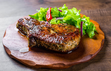 Pork Loin chops marinated meat Steak with vegetables slad on wooden table background