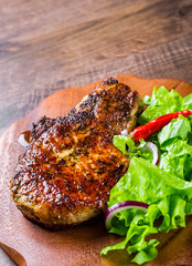 Pork Loin chops marinated meat Steak with vegetables slad on wooden table background